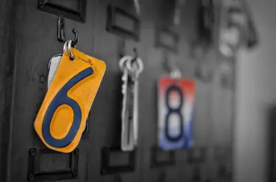 a tag with the number six hanging on a wall at Harwood Hill Motel in Bennington