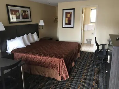 a hotel room with a bed in a room at Whitney Inn & Suites in Hamden