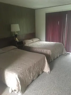 a hotel room with two beds and a lamp at Michael Dee's Motel in East Durham