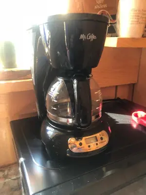 a coffee maker sitting on top of a stove at Michael Dee's Motel in East Durham