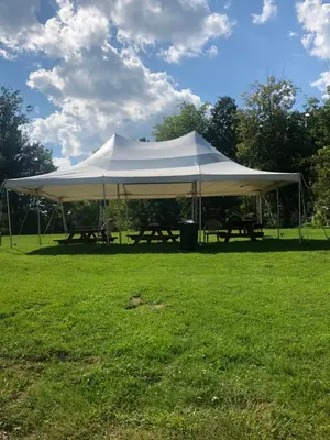 a large white tent in a grass field at Michael Dee's Motel in East Durham