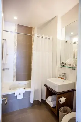 a bathroom with a white tub and a sink and a bath tubermott at Aura Hotel Brooklyn in Brooklyn