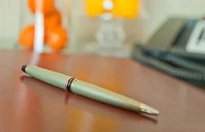 a pen sitting on top of a wooden table at Aura Hotel Brooklyn in Brooklyn