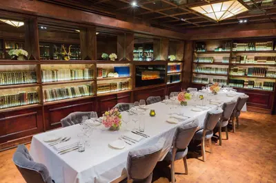 a room with a long table in a library at Sanctuary Hotel New York in New York