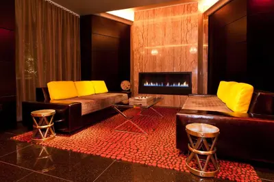 a living room with a couch and a fireplace at Sanctuary Hotel New York in New York