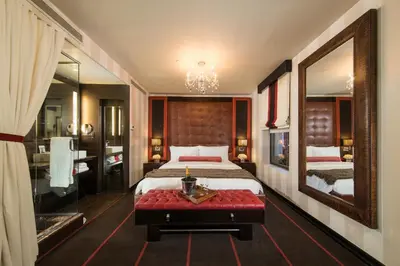 a bedroom with a bed and a large mirror at Sanctuary Hotel New York in New York