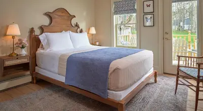 a bedroom with a large bed and a window at Landmark Inn in Cooperstown