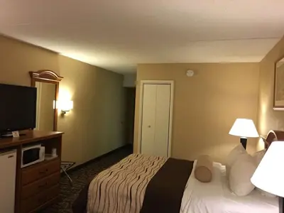 a hotel room with a bed and a flat screen tv at Best Western Clifton Park in Clifton Park