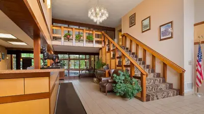 a lobby with a staircase in a building at Best Western Clifton Park in Clifton Park