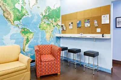 a waiting room with a map of the world on the wall at Central Park West Hostel in New York