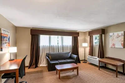 a living room with a couch and a chair at The Hotel Saratoga, an Ascend Collection Hotel in Saratoga Springs