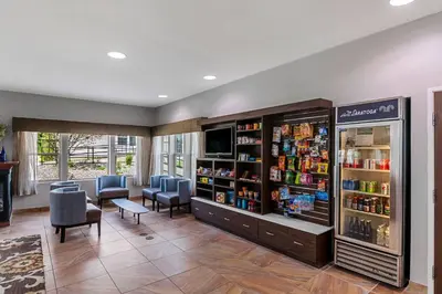 a waiting room with a pharmacy with chairs and a refrigerator at The Hotel Saratoga, an Ascend Collection Hotel in Saratoga Springs