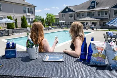 two women sitting at a table with a glass of wine at The Hotel Saratoga, an Ascend Collection Hotel in Saratoga Springs