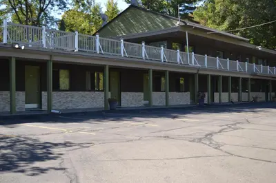 a building with a white balcony on top of it at Mount Holyoke Inn in Holyoke