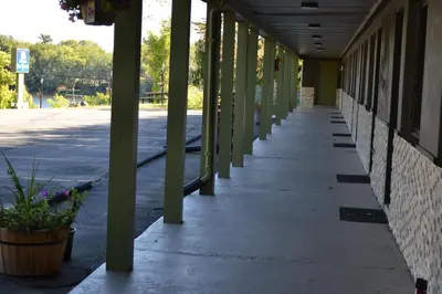 an empty hallway of a building with green columns at Mount Holyoke Inn in Holyoke