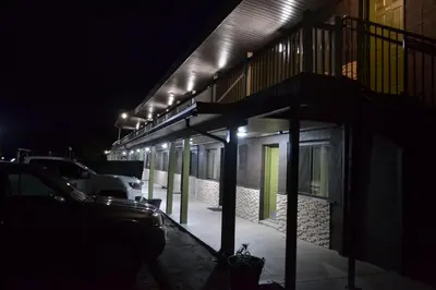 a building lit up at night with cars parked outside at Mount Holyoke Inn in Holyoke