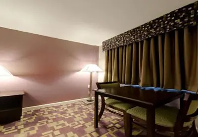 a hotel room with a table and a chair at Mount Holyoke Inn in Holyoke