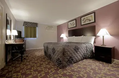 a hotel room with a bed and a desk at Mount Holyoke Inn in Holyoke