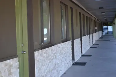 an empty hallway of a building with windows at Mount Holyoke Inn in Holyoke