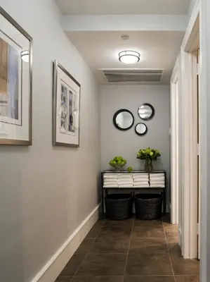 a hallway with three mirrors on the wall at Hotel Lucerne in New York