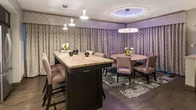 a dining room with a table and chairs at Best Western PLUS Franklin Square Inn in Troy
