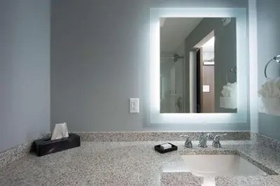 a bathroom with a sink and a mirror at Best Western PLUS Franklin Square Inn in Troy