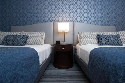 a hotel room with two beds and a lamp at Best Western PLUS Franklin Square Inn in Troy