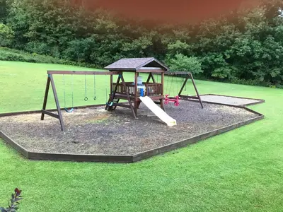 a playground with a swing in a yard at Coolis Apartment in Richfield Springs