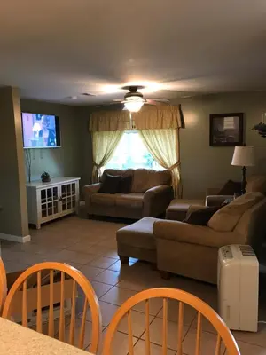 a living room with a couch and a tv at Coolis Apartment in Richfield Springs