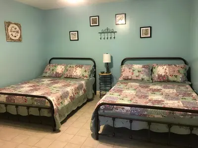 two beds in a room with blue walls at Coolis Apartment in Richfield Springs