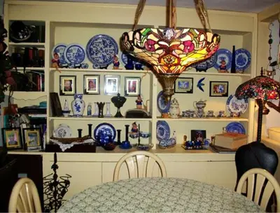 a dining room with blue and white plates and a table at A Meadow House in Lakeville