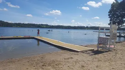 a man is standing on a ramp in the water at A Meadow House in Lakeville