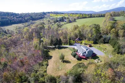 an aerial view of a large house on a field at The Guest House in Margaretville