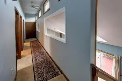 a hallway of a house with a rug on the floor at The Guest House in Margaretville