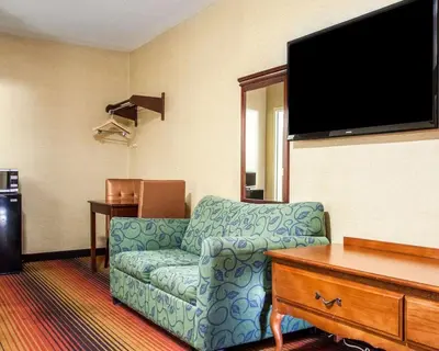 a living room with a couch and a flat screen tv at Rodeway Inn Jersey City North in Jersey City