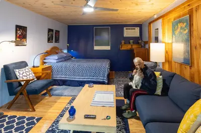 a dog sitting on a couch in a living room at Cavalier Cottage B&B in Shelburne Falls