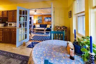 a kitchen with a table and a room with a table at Cavalier Cottage B&B in Shelburne Falls