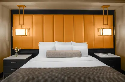 a bedroom with a bed with two lights above it at Mount Airy Casino Resort - Adults Only 21 Plus in Mount Pocono