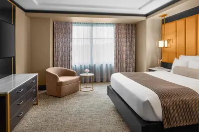 a hotel room with a bed and a chair at Mount Airy Casino Resort - Adults Only 21 Plus in Mount Pocono