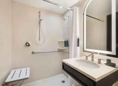 a bathroom with a sink and a shower at Hilton New York Fashion District in New York
