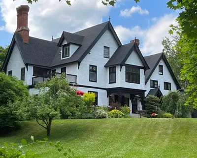 a large white house with a large yard at Manor House Inn in Norfolk
