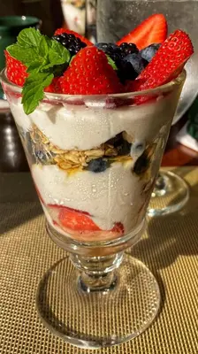 a dessert with fruit in a glass dish on a table at Manor House Inn in Norfolk