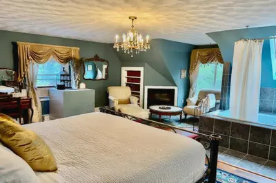 a bedroom with a bed and a living room at Manor House Inn in Norfolk