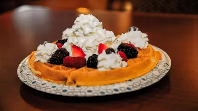a waffleecake with fruit on a plate on a table at Hampton Inn Matamoras in Matamoras