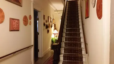 a staircase leading up to the second floor of a house at The Historic Mansion in New Haven