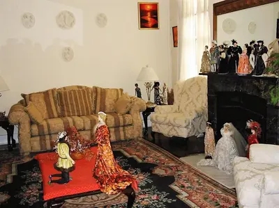 a living room with figurines on a table in front of a fireplace at The Historic Mansion in New Haven