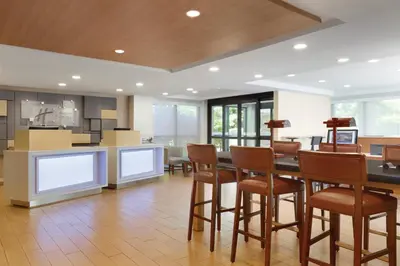 a kitchen and dining room with a table and chairs at Holiday Inn Express Hartford South - Rocky Hill by IHG in Rocky Hill
