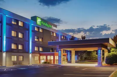 a hotel with a blue lit up building at Holiday Inn Express Hartford South - Rocky Hill by IHG in Rocky Hill