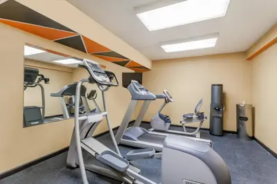 a gym with treadmills and elliptical machines at Days Inn by Wyndham Windsor Locks / Bradley Intl Airport in Windsor Locks