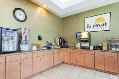 a fast food restaurant with a clock on the wall at Days Inn by Wyndham Windsor Locks / Bradley Intl Airport in Windsor Locks